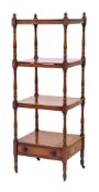 An early 19th Century mahogany four-tier whatnot: with turned finials and baluster turned uprights,