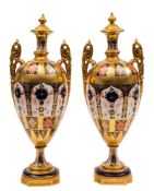 A pair of Royal Crown Derby two-handled vases and integral covers: in the 'Old Imari' pattern with