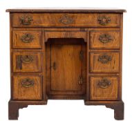 An early 18th Century walnut and diagonally banded kneehole desk:, of small size,