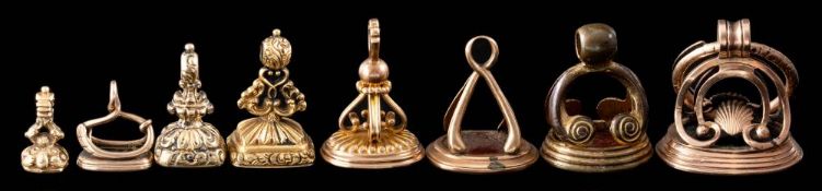 A collection of eight fob seals: including an early 19th Century gold seal with bloodstone intaglio