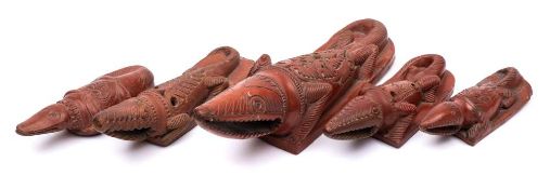 A group of five Sudanese red earthenware body scrapers: in the form of crocodiles,