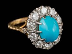 A turquoise and diamond oval cluster ring: the oval turquoise approximately 10mm long x 7.