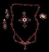 A Georgian flat garnet necklace: with oval and circular garnets in closed back settings and