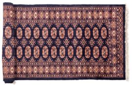An Indo Persian runner:, the indigo field with two rows of quartered guls,