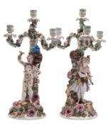 A pair of Sitzendorf four-light candelabra: modelled as male and female jesters with monkey