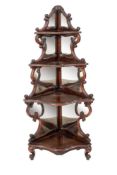 A Victorian carved rosewood serpentine fronted four tier standing corner whatnot:,