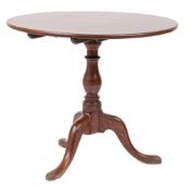 A George III mahogany circular tea table: with a snap top,