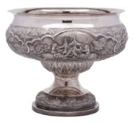 An Indian silver pedestal bowl: with embossed decoration of village scenes with elephants,