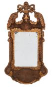 A Continental walnut and giltwood wall mirror: of cartouche outline,