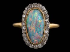 A black opal and diamond oval cluster ring: the oval black opal approximately 14.5mm long x 7.