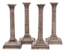 A near matching set of four Victorian silver Corinthian column candlesticks, maker Hawksworth,