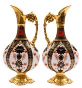 A pair of Royal Crown Derby ewers: in the 'Old Imari' pattern with solid gold borders,
