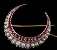 A 19th Century ruby and diamond crescent brooch: set with graduated round,