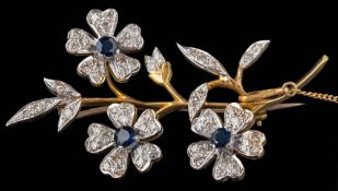 An 18ct gold, sapphire and diamond floral spray brooch: approximately 54mm long, 12gms gross weight.