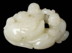A Chinese carved jade figure group: of two seated figures beside a recumbent qilin, 7.5cm. wide.