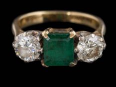 An emerald and diamond three-stone ring: with central rectangular emerald 6.5mm x 6.