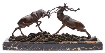 After Irenee Rochard (1906-1984) A bronze study of rutting stags on a rocky plinth,