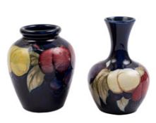 Two Moorcroft pottery small vases: one of globular form with raised flaring neck the other of