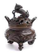 A Japanese bronze koro and cover: the pierced shallow domed lid surmounted with a dragon,