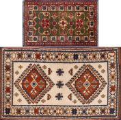 A Kurdish rug:, the ivory field with twin lozenge stepped geometric medallions,