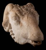 A carved white marble life-size ram's head fountain: in the Hellenic style, with open mouth, 24cm.