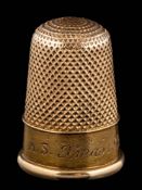 A thimble initialled and dated '1891', together with fitted case stamped 'Harrods London S.W'.