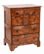 An 18th Century burr yew-wood and oak Norfolk chest:, the top with a moulded edge,