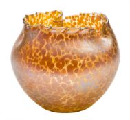 A glass vase in the Loetz manner: of oviform with serrated asymmetric rim the pale amber body with