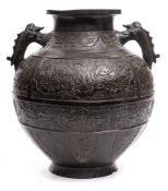 A large Chinese bronze vase: of ovoid form, with banded decoration and Taoist symbols,
