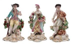 A pair of Derby bocage figures of the Seasons and a similar figure of a sportsman: Summer holding a