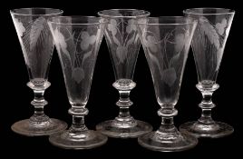 A group of five dwarf ale glasses: the funnel bowls engraved with fruiting hops and barley,