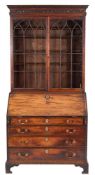 A George III mahogany bureau bookcase:,