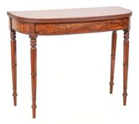 An early 19th Century mahogany tea table: of D-shaped outline, the hinged top with a reeded edge,