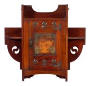 Shapland and Petter A mahogany and oxidised metal mounted wall cabinet:, of shaped outline,