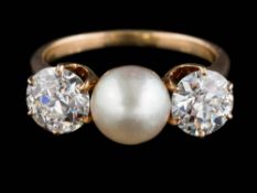 A gold, pearl and diamond three-stone ring: with central button pearl 7.