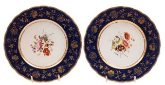 A pair of Rockingham dessert plates: each painted with a floral bouquet within a blue ground basket