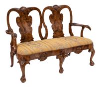 An early 18th Century and later carved walnut twin chair back settee:,