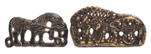 Two Chinese bronze buckles: one decorated with a horse-drawn cart,