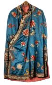 An early 20th century Chinese silk cape: the collar embroidered with butterflies and flowerheads,