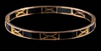 A black onyx panel bangle of pierced design: inside circumference approximately 73mm,