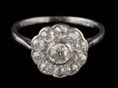 A 20th Century diamond circular cluster ring: mille-grain-set with round old,