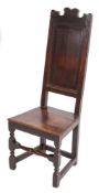 A late 17th/early 18th Century oak dining chair:, the high fielded panel back with shaped cresting,