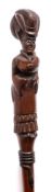 A carved hardwood walking stick: the handle in the form of a lady in a long dress,