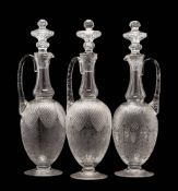 A set of three Webb Corbett 'crystal' glass claret jugs and stoppers retailed by Royal Doulton: in