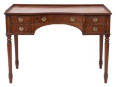 A late 19th Century mahogany dressing table: of recessed breakfront outline,