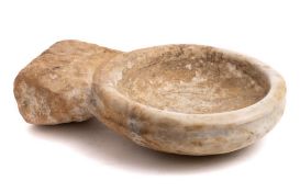 A carved marble Holy Water stoop: of circular outline with rectangular fixing stud,