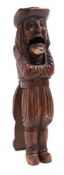 A German carved treen figural nutcracker: of a long haired gentleman in 16th century costume