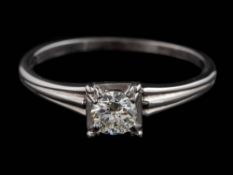 A diamond single-stone ring: the round, brilliant-cut diamond estimated to weigh 0.