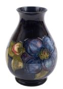 A Moorcroft pottery vase: of tear drop form with flaring neck tubelined in the blue Clematis