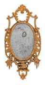 An 18th Century carved giltwood mirror: of cartouche-shaped outline, having open cartouche,